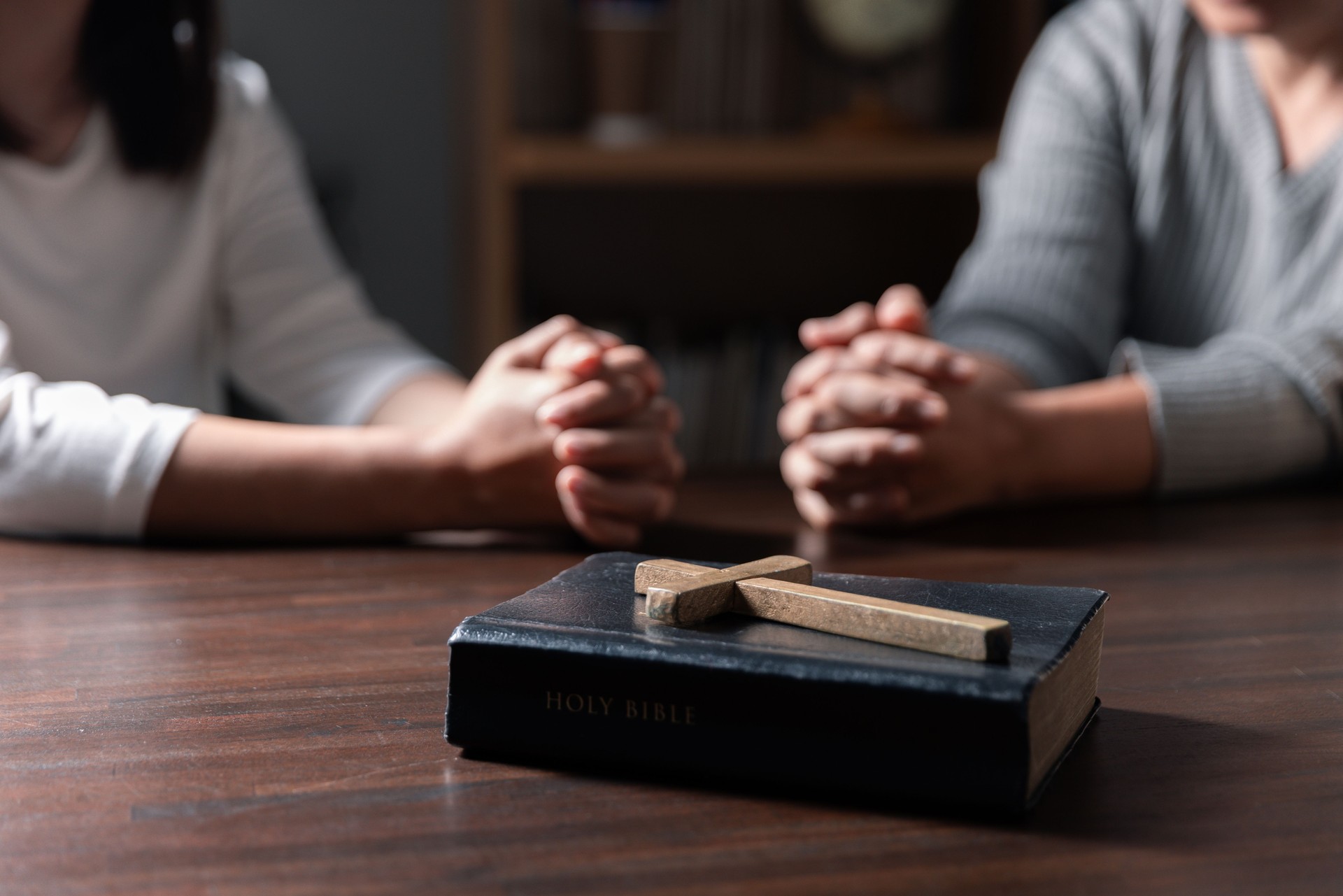 Group of different women praying together, Christians and Bible study concept.